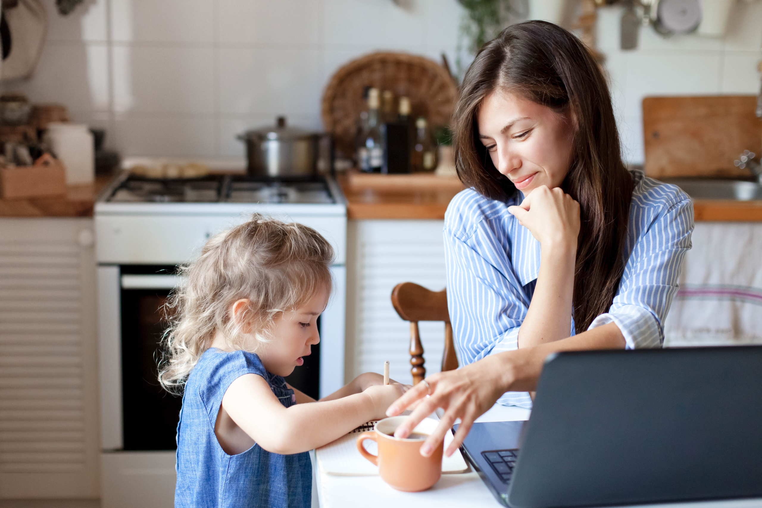 working-mom-works-from-home-office-with-kid-woman-and-cute-child-using-laptop